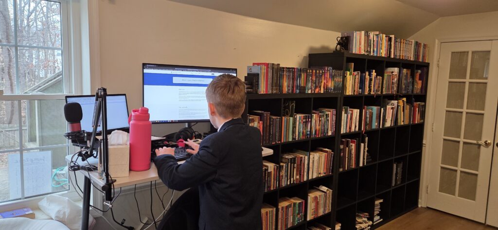 Child editing Legacy Haven Academy About Us page.